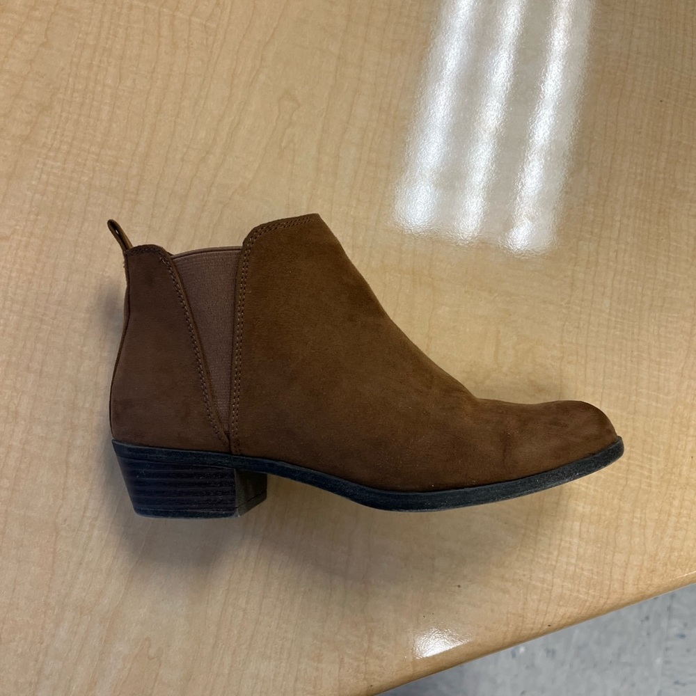 Brown low cut boots.